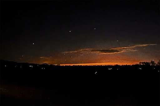 This photo provided by Trisha Bushey shows the evening sky and points of light near in Lebanon Town…