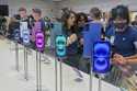 People gather near a display of iPhone 16's at the Apple Store on 5th Ave