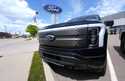 An unsold 2024 Lightning electric pickup truck sits at a Ford dealership May 19, 2024, in Denver