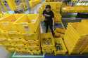 An employee scans incoming items at a receiving station at the Amazon OXR1 fulfillment center in Ox…