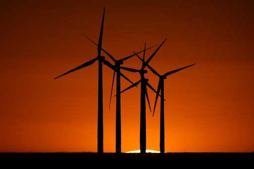 Wind turbines are silhouetted against the setting sun at the Spearville Wind Farm, Sunday, Sept