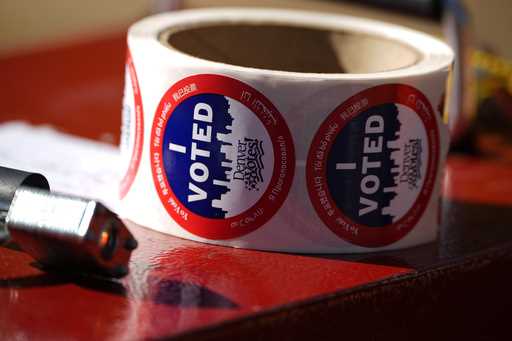 Stickers for voters sit in a roll on a ballot box at a voting drop-off location Friday, October 25,…