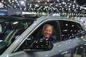 President Joe Biden drives a Cadillac Lyriq through the show room during a tour at the Detroit Auto…