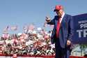 Republican presidential candidate former President Donald Trump walks to the podium at a campaign e…