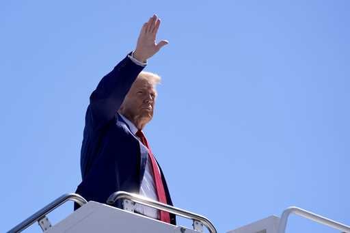 Republican presidential nominee former President Donald Trump waves as he boards a plane at Harry R…