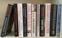 A collection of books about President Donald Trump, from left, "Siege" by Michael Wolff, "Devil's B…