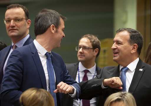 FILE -Croatian Health Minister Vili Beros, right, bumps elbows to say hello to French Health Minist…