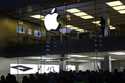 People wait in front of the Apple store in Munich, Germany, on Sept