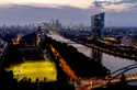 The European Central Bank stands at right as soccer players practise on a field next to the river M…