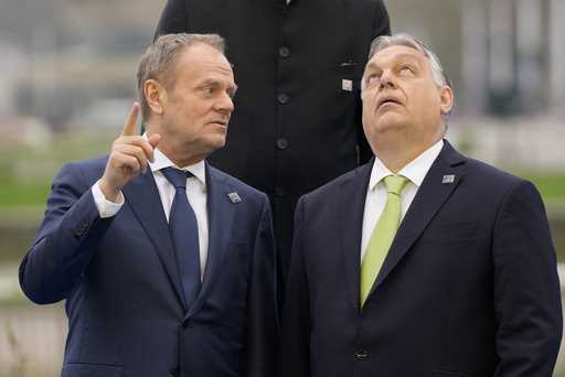 Hungary's Prime Minister Viktor Orban, right, speaks with Poland's Prime Minister Donald Tusk as th…