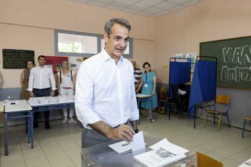 Greece's Prime Minister Kyriakos Mitsotakis casts his ballot during the European Elections in Athen…