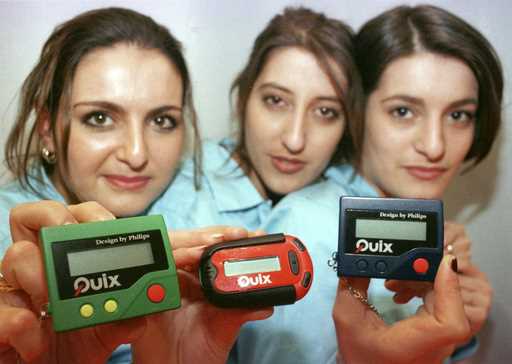 Three women hold the pager 'Quix' as they present it at CeBIT '97 in Hannover, Germany, Tuesday Mar…