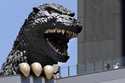 People take a picture of Godzilla's head at Shinjyuku Toho building at the Kabukicho district in To…