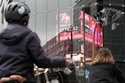 People stand in front of an electronic stock board showing Japan's Nikkei index at a securities fir…