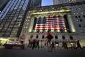 People pass the New York Stock Exchange on November 5, 2024, in New York