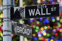 A sign outside the New York Stock Exchange marks the intersection of Wall and Broad Streets, Decemb…