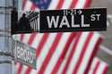 A sign outside the New York Stock Exchange marks the intersection of Wall and Broad Streets, Tuesda…