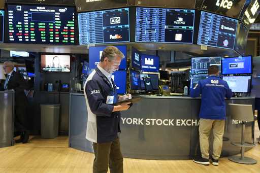 People work on the floor at the New York Stock Exchange in New York, Thursday, February 27, 2025