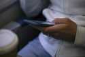 A woman looks at a hand held device on a train in New Jersey on May 18, 2021