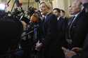 French far-right leader Marine Le Pen, center, answers reporters at the National Assembly and confi…