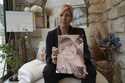 Stephanie Mistre, 51, holds a picture of her daughter, Marie Le Tiec, a teenager who died by suicid…