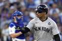 New York Yankees' Juan Soto celebrates after hitting a home run against the Los Angeles Dodgers dur…