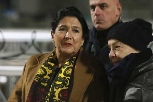 Georgian President Salome Zourabichvili, left, attends an anti-government rally outside the Parliam…