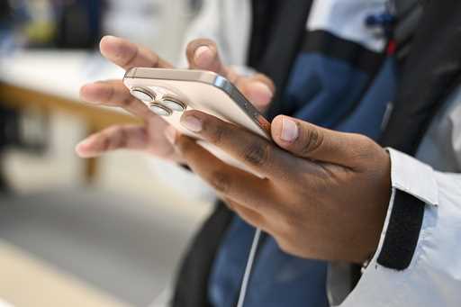 A man looks at the new iPhone 16 in the Apple store as the iPhone 16 with artificial intelligence s…