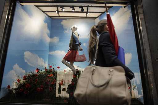 A woman walks past the Gucci store window at the Via Montenapoleone fashion district, during the Mi…