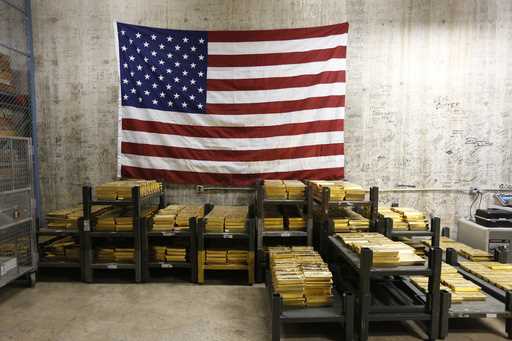 Gold bars are stacked in a vault at the U