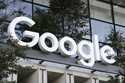 A Google sign hangs over an entrance to the company's new building, Sept