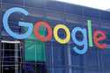 A sign is displayed on a Google building at their campus in Mountain View, Calif