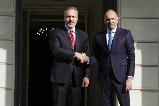 Greek Foreign Minister George Gerapetritis, right, welcomes his Turkish counterpart Hakan Fidan bef…