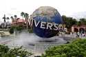 Guests cool off under a water mist by the globe at Universal Studios City Walk at Universal Studios…