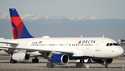 Delta Airlines jetliner taxis down a runway as it arrives at Denver International Airport, Tuesday,…