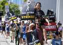 Director of Photography Jac Cheairs and his son, actor Wyatt Cheairs, 11, take part in a rally by s…