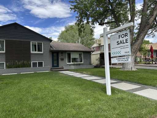 A for sale sign stands outside a single-family home Thursday, June 27, 2024, in Englewood, Colo