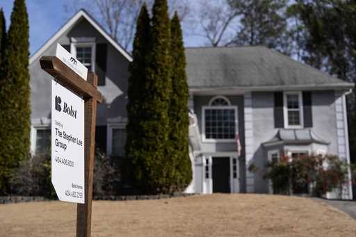 A sign announcing a home for sale is posted outside a home, February 1, 2024, in Kennesaw, Ga