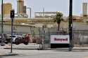 Construction workers pave a parking lot at a Honeywell plant on April 4, 2020, in Phoenix