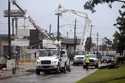Utility crews work to restore electricity in Houston, Thursday, July 11, 2024