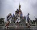 Guests weather early bands of rain from Hurricane Milton at the Magic Kingdom at Walt Disney World …