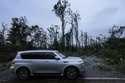 Vehicles move slowly around trees that have fallen after Hurricane Helene moved through the area, F…