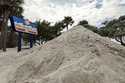 Sand washed ashore by the surge of Hurricane Helene is piled, October 2, 2024, in Treasure Island, …