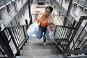 Sofia Roca, a 49-year-old immigrant from Colombia, climbs a stairway inside her apartment complex i…