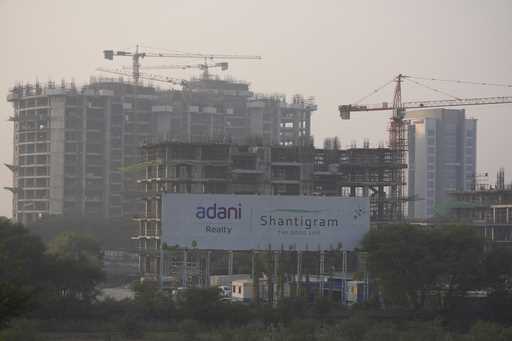 Construction workers work at a construction site of Adani group near Adani Corporate House in Ahmed…