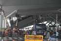 A crew inspects the damage to a part of a departure terminal canopy at New Delhi’s Indira Gandhi In…