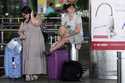 Traveller Lauren Clark, left, and Shahin Jade Ali wait at Chhatrapati Shivaji Maharaj International…