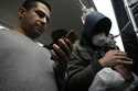 A man uses his smartphone while riding the subway in Tehran, Iran, Tuesday, December 24, 2024