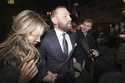 Mixed martial arts fighter Conor McGregor and partner Dee Devlin leave the High Court in Dublin, Ir…