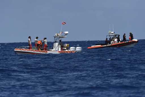 Emergency services at the scene of the search for a missing boat, in Porticello, southern Italy, Tu…